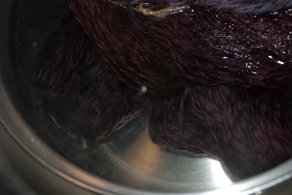 A dye kettle with wool in it