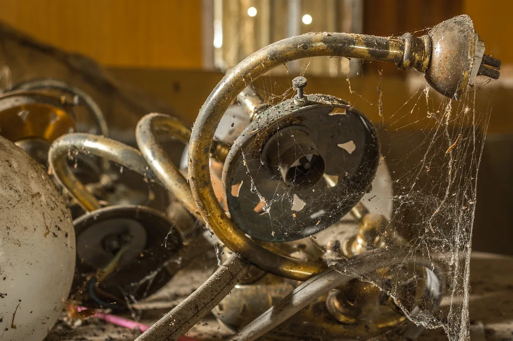 Cobwebs strung across old abandoned machinery