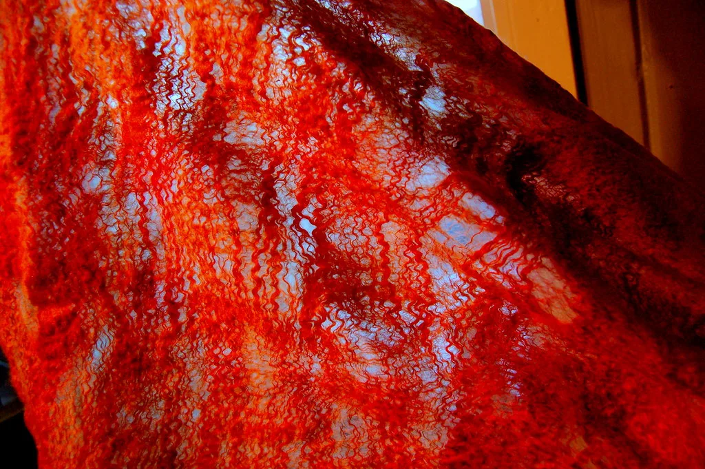 A cobweb felted scarf, lace-thin with open holes