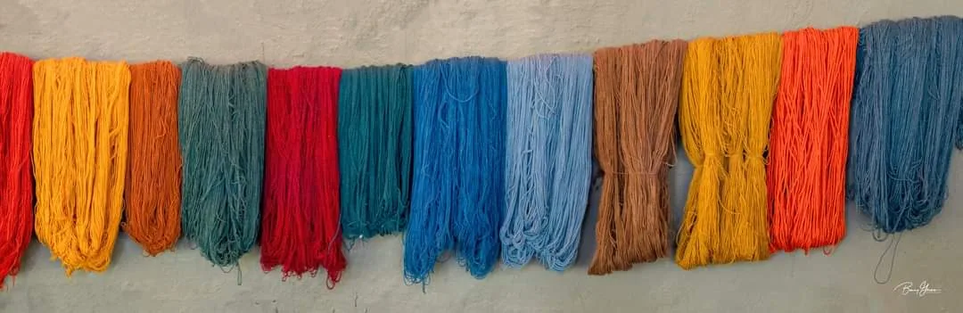 Wool being dyed by hand in a heated bath