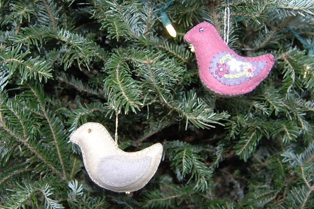 Small felt bird ornaments hanging on a string