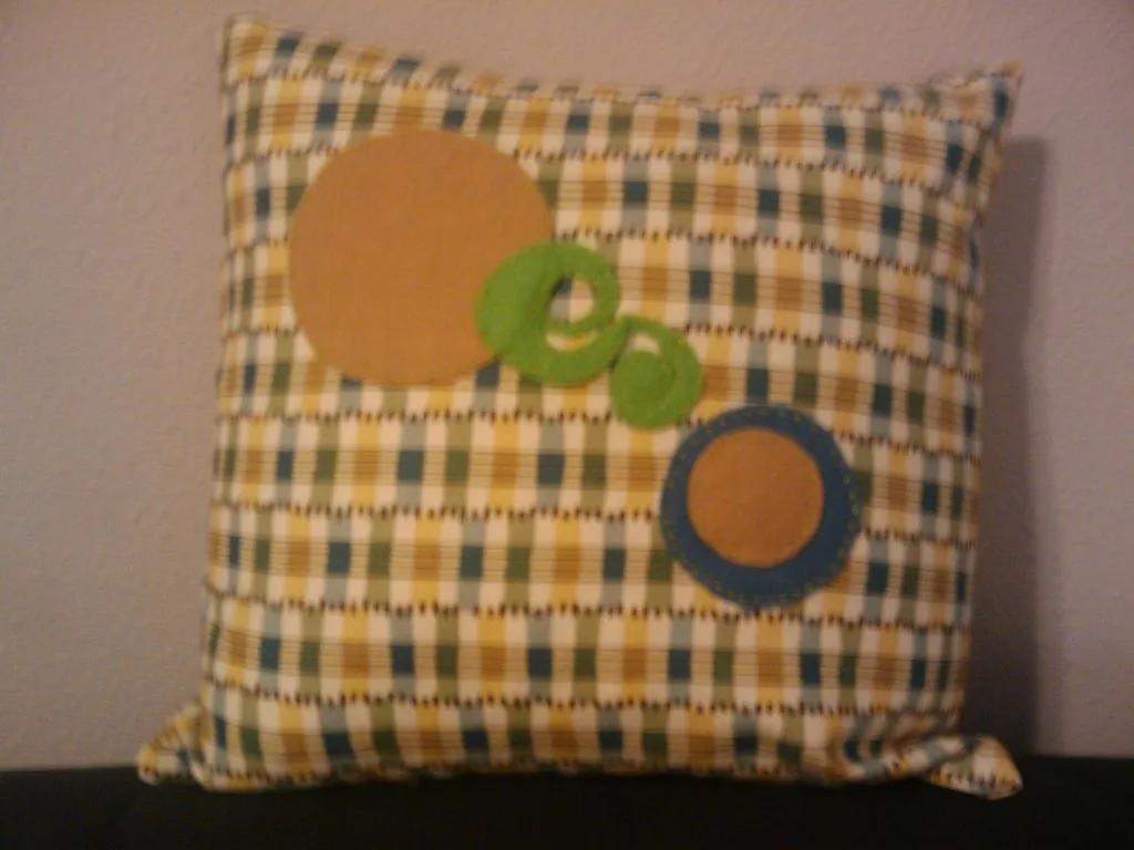 Felt shapes appliqued onto a cushion cover