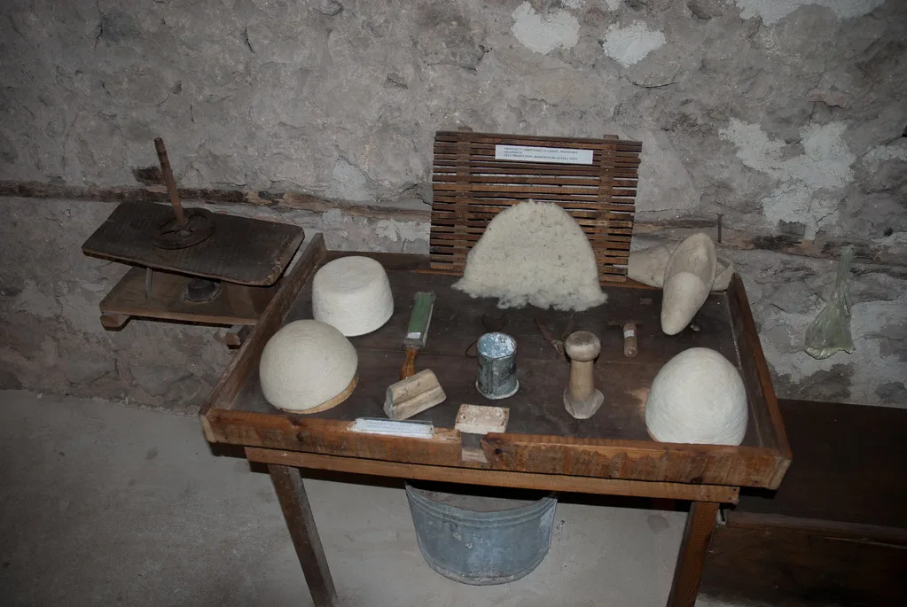 Felt hat making, a blank being shaped into a hat