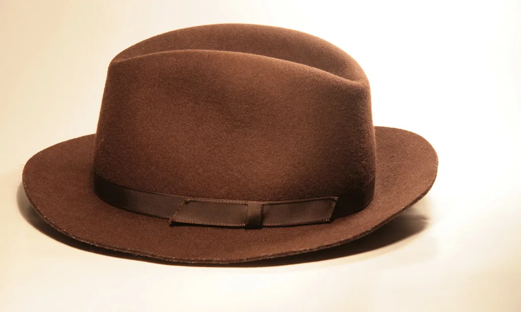 A brown felt fedora with a creased crown and snapped brim