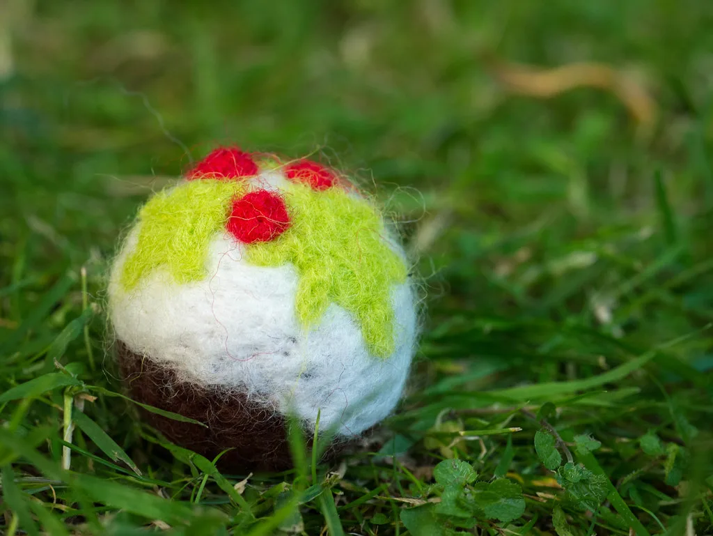 A needle felted Christmas pudding decoration