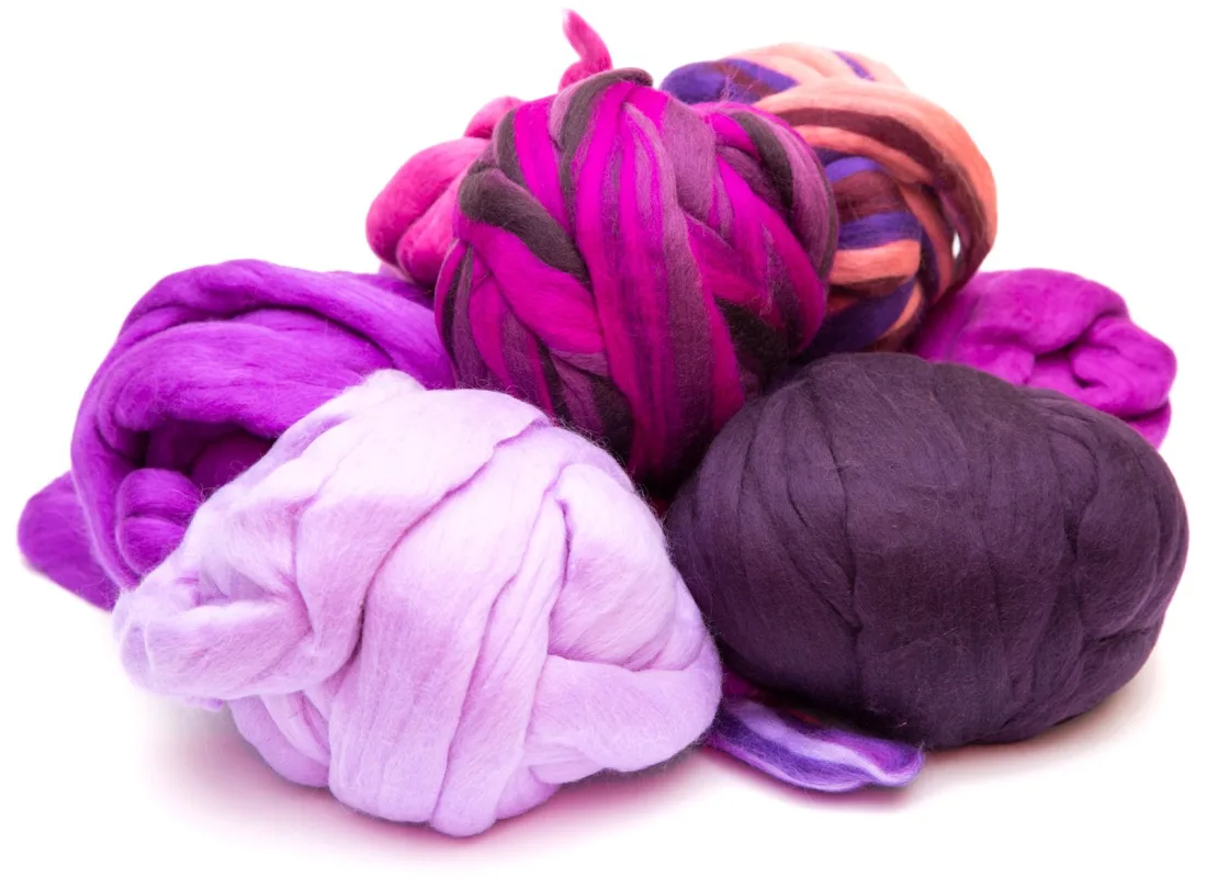 Bundles of merino wool tops in purple, lilac, magenta and dark plum, with one striped multicoloured bundle