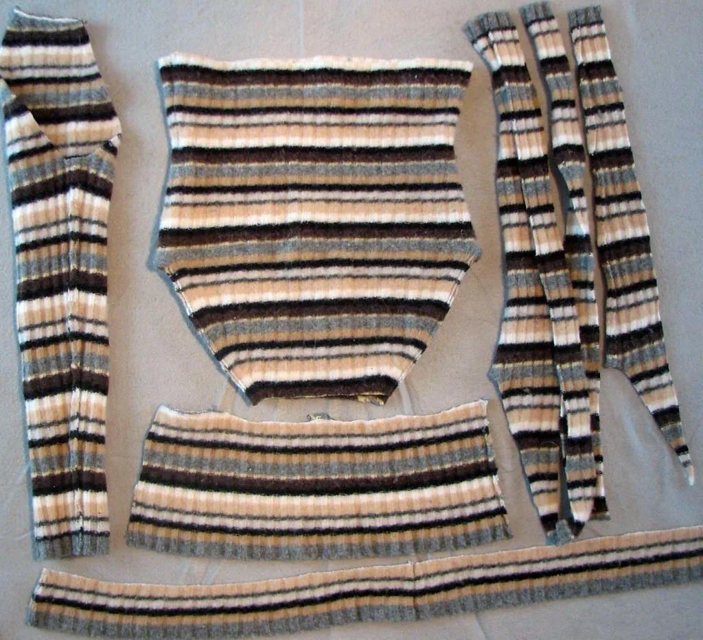 A jumper cut open into flat panels, with the cuffs and hem kept intact