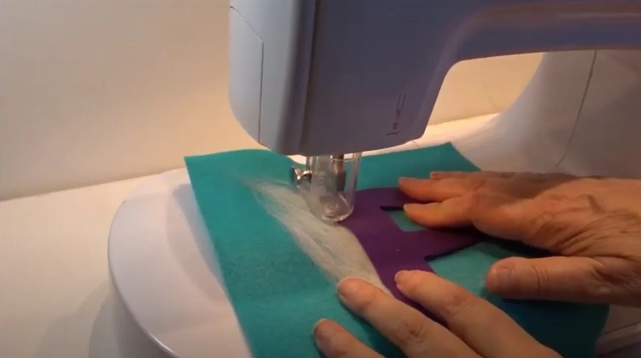 Layers of fabric being needle punched together on a felting machine