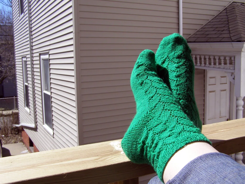 Socks knitted in a falling leaves pattern