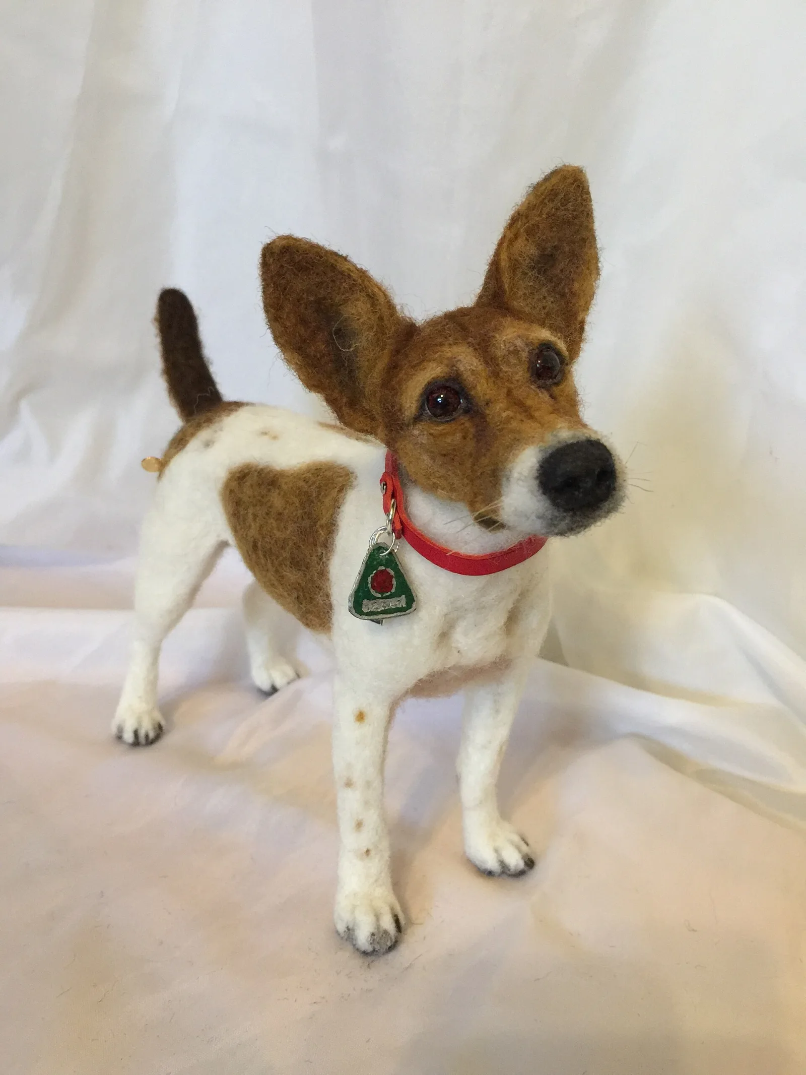 A needle felted terrier made as a likeness of a real dog