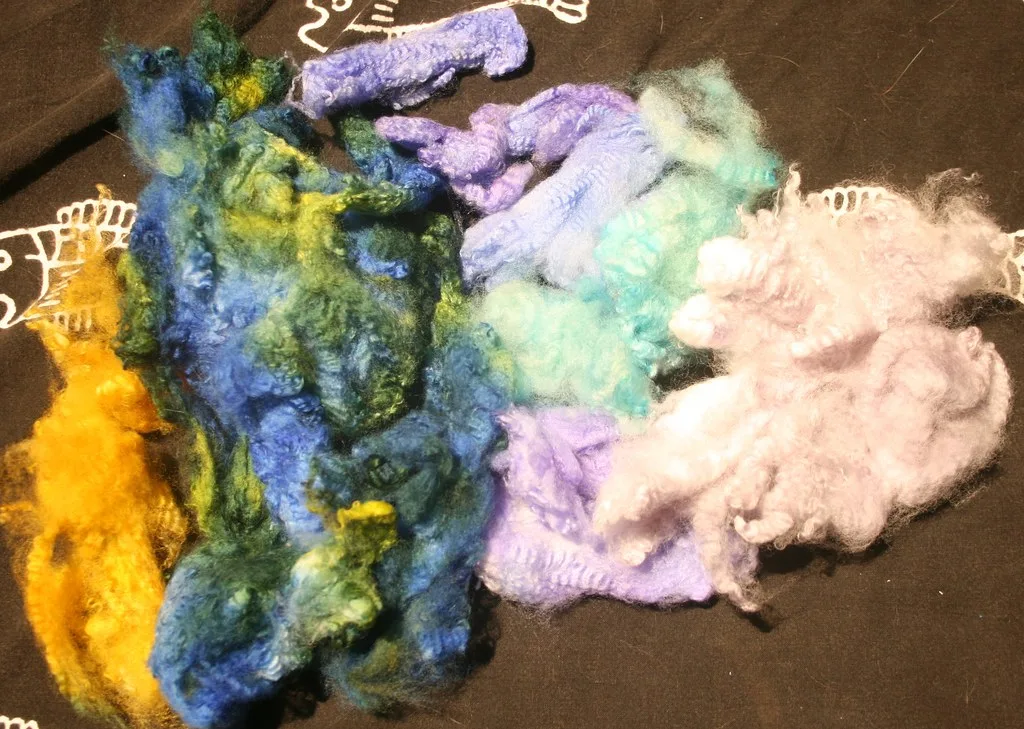 Separated wool locks in several colours, including undyed white