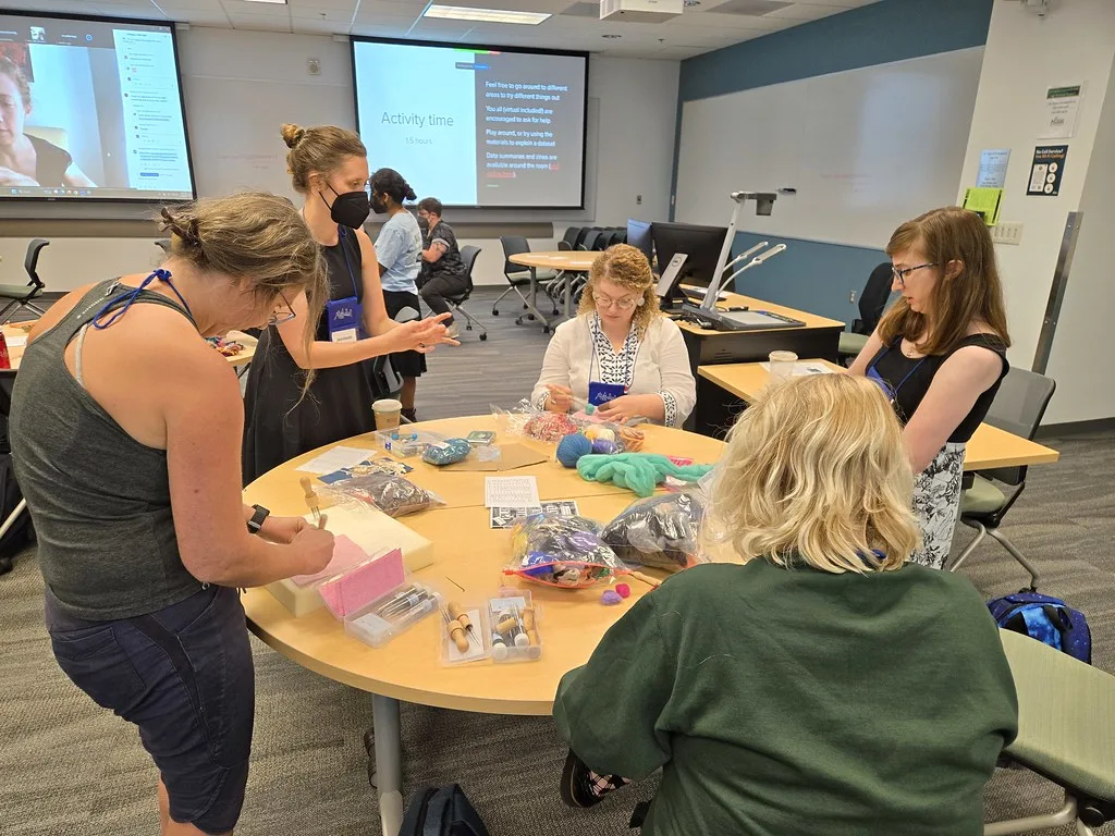 A needle felting class working at a shared table