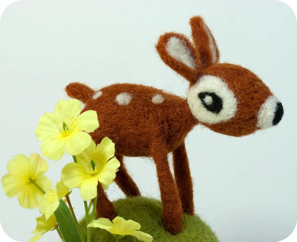 A needle felted animal with a raised, brushed coat