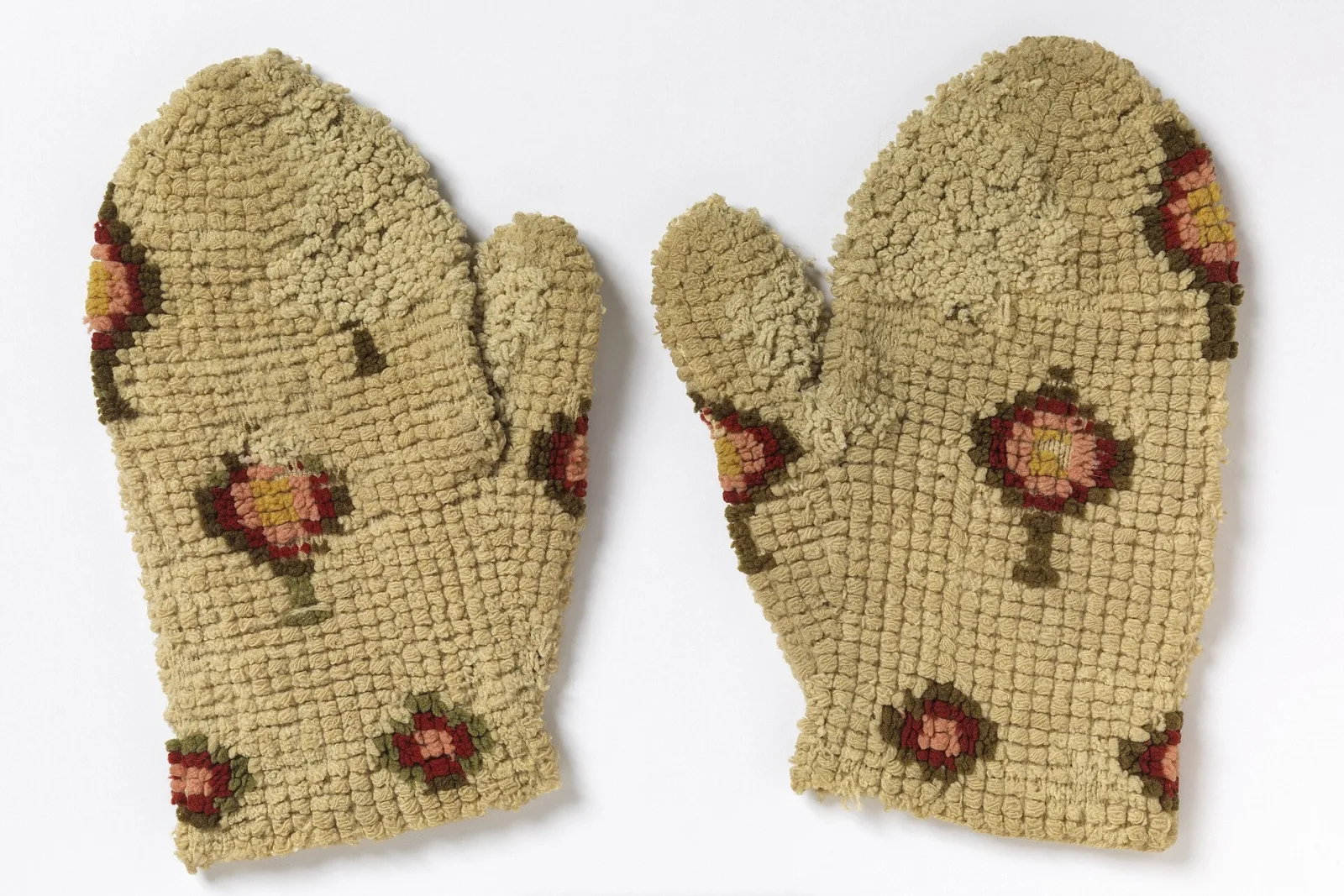 A pair of thick wool mittens