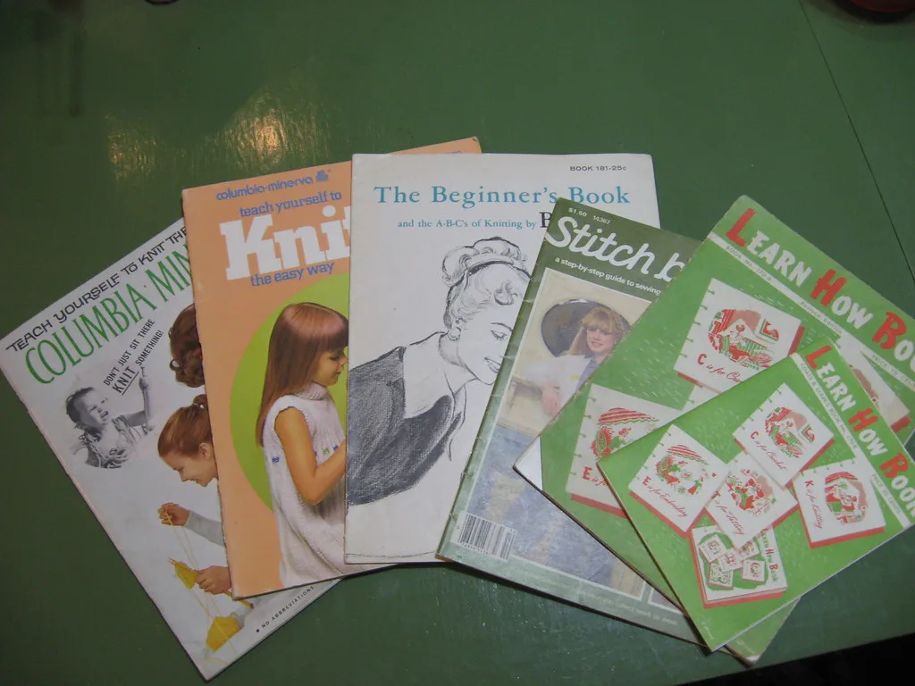 Second-hand craft instruction booklets laid out on a table