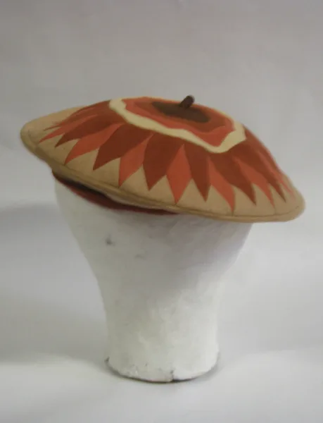 A wool felt beret with a flat crown and a close-fitting band