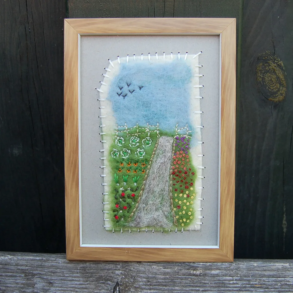 A framed picture made from loose wool fibre