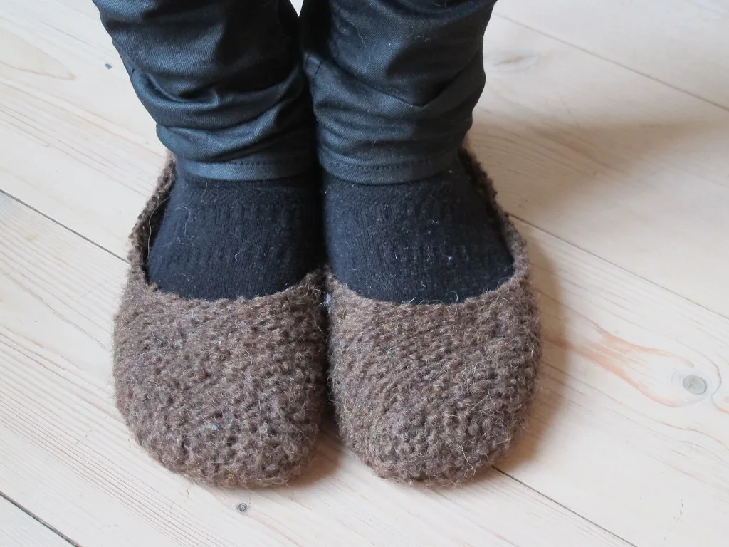 Wool slippers worn on the feet on a hard floor